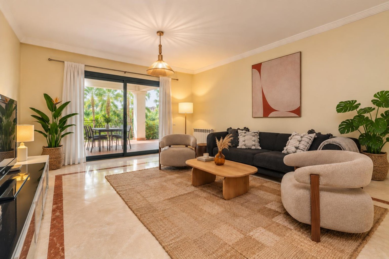Bright living room with comfortable seating and glass doors onto the private terrace