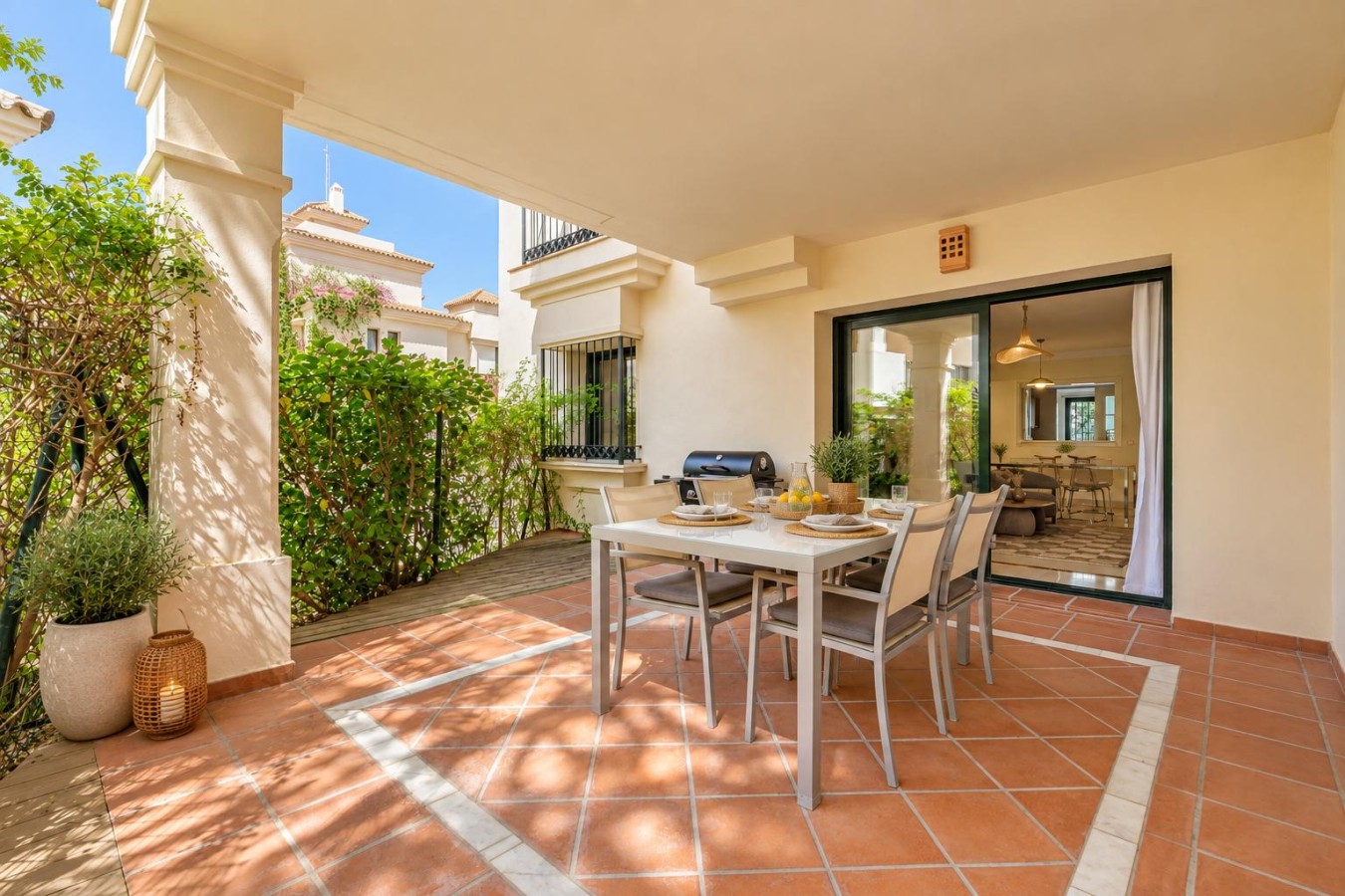 Shaded terrace seating just outside the living room doors