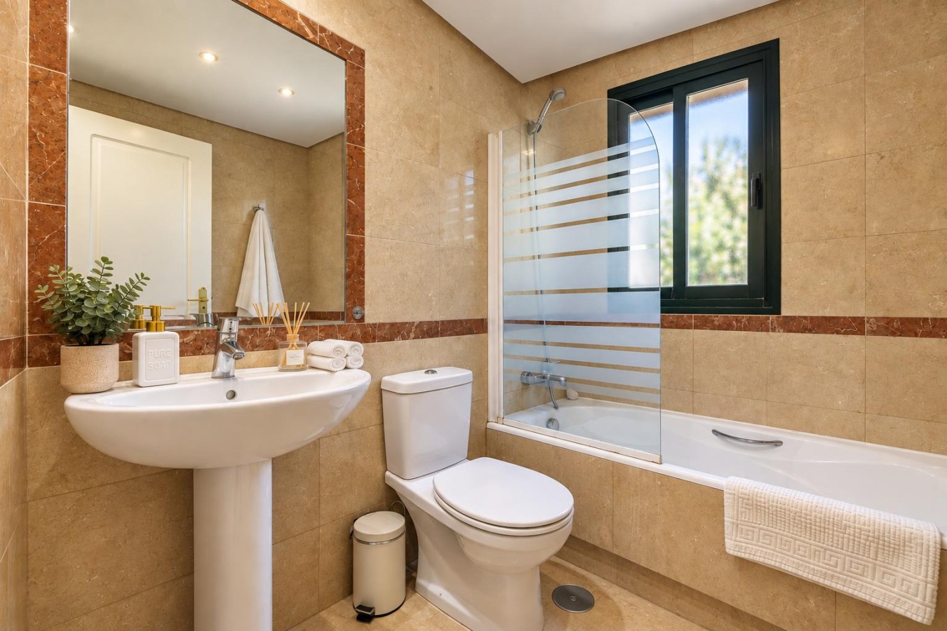 Second bathroom with bath, shower screen, and WC