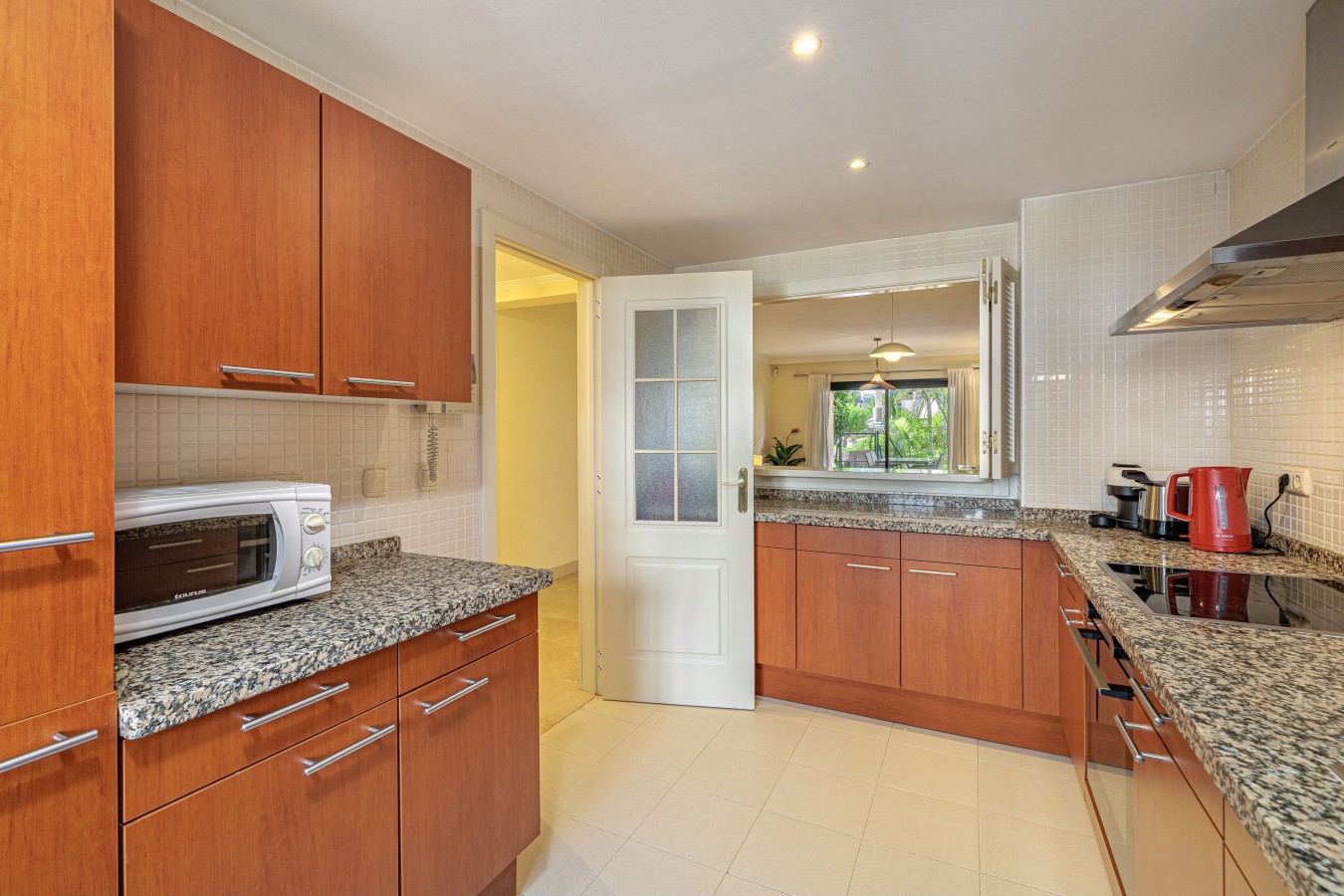 Kitchen with microwave, hob, and generous storage