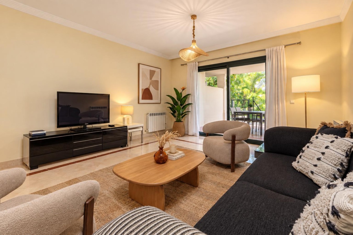Living room seating with TV and direct access to the private terrace