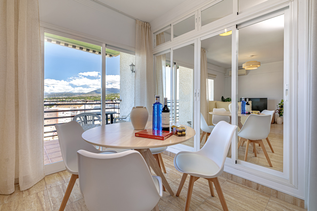 Spacious dining area featuring large mirrored wardrobes for ample storage.