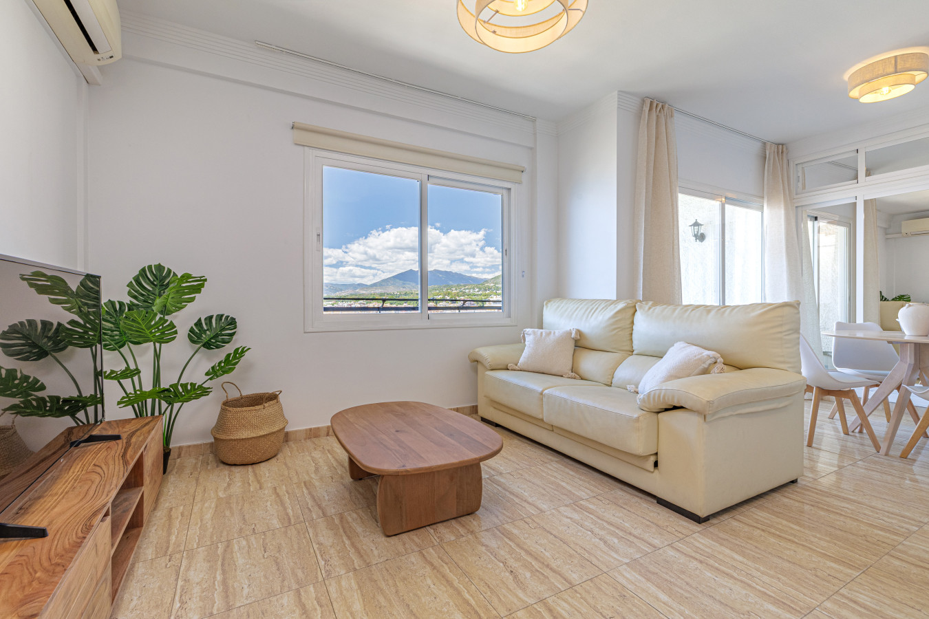 Bright and modern living room with air conditioning and natural light.
