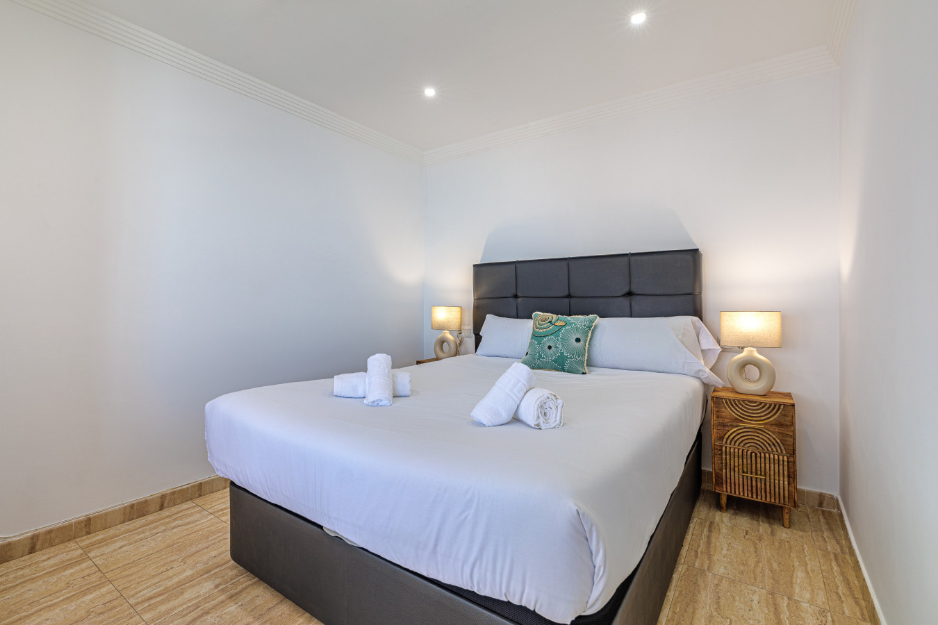 Restful, air-conditioned bedroom with premium linens and modern decor.