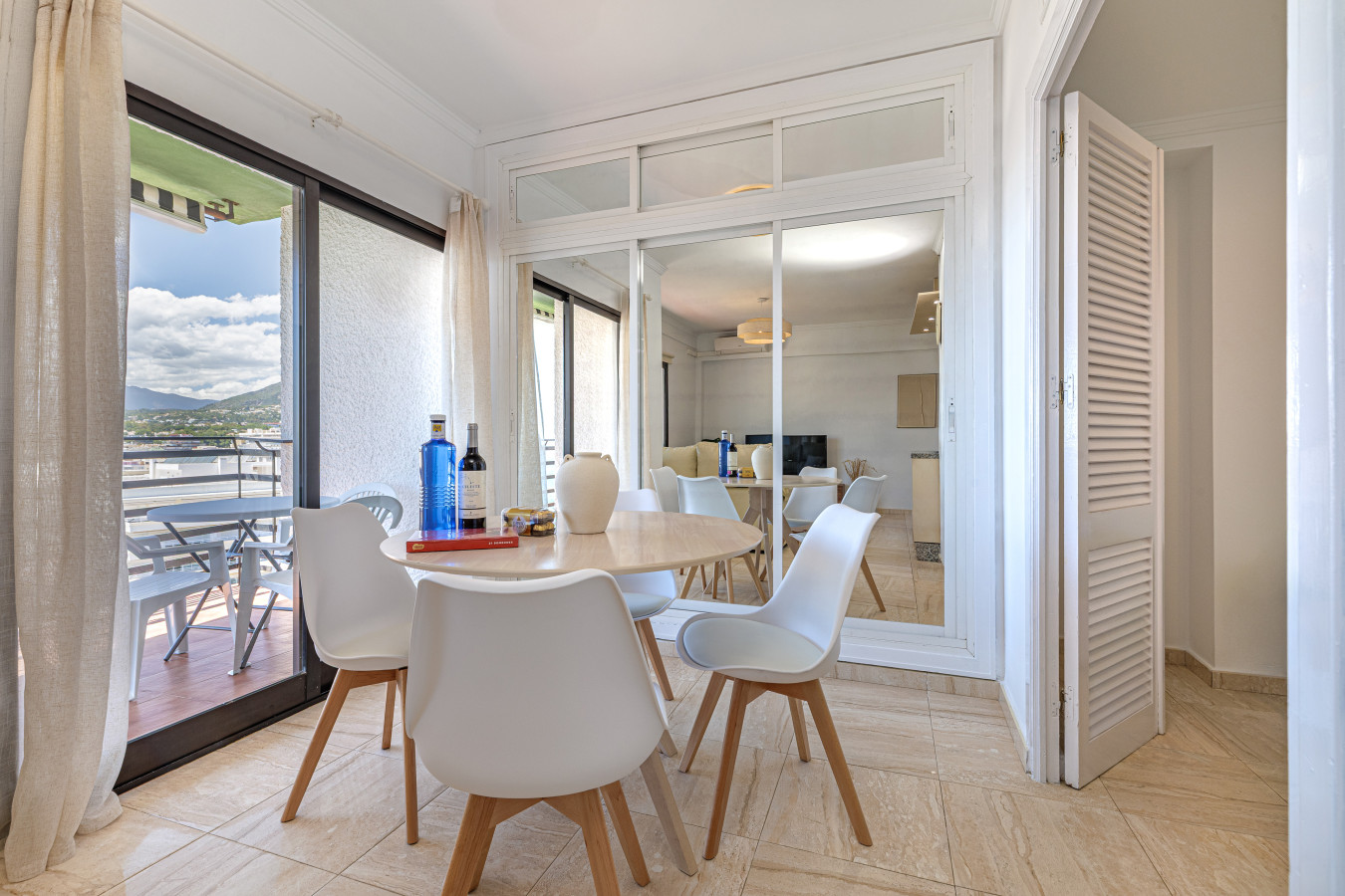 Bright and airy dining space with floor-to-ceiling windows overlooking the Mediterranean Sea.
