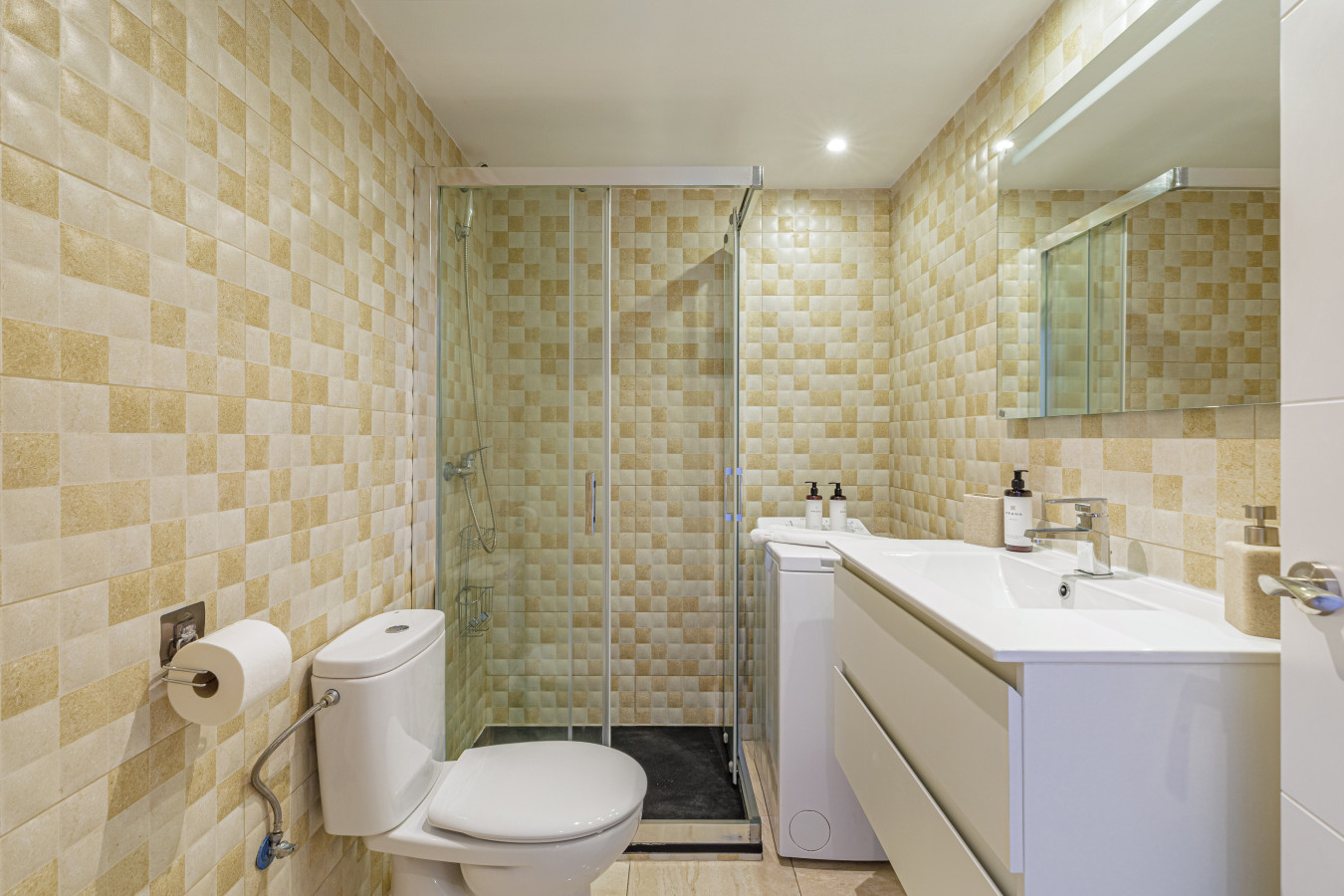 Modern, spotlessly clean bathroom featuring a spacious walk-in glass shower.