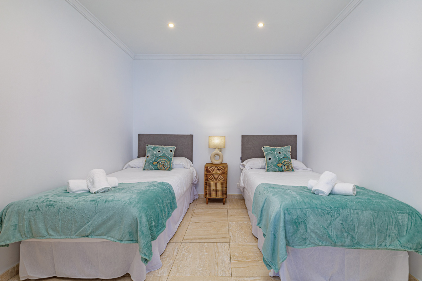 Comfortable bedroom with twin beds and fresh linens for a restful night in Marbella.