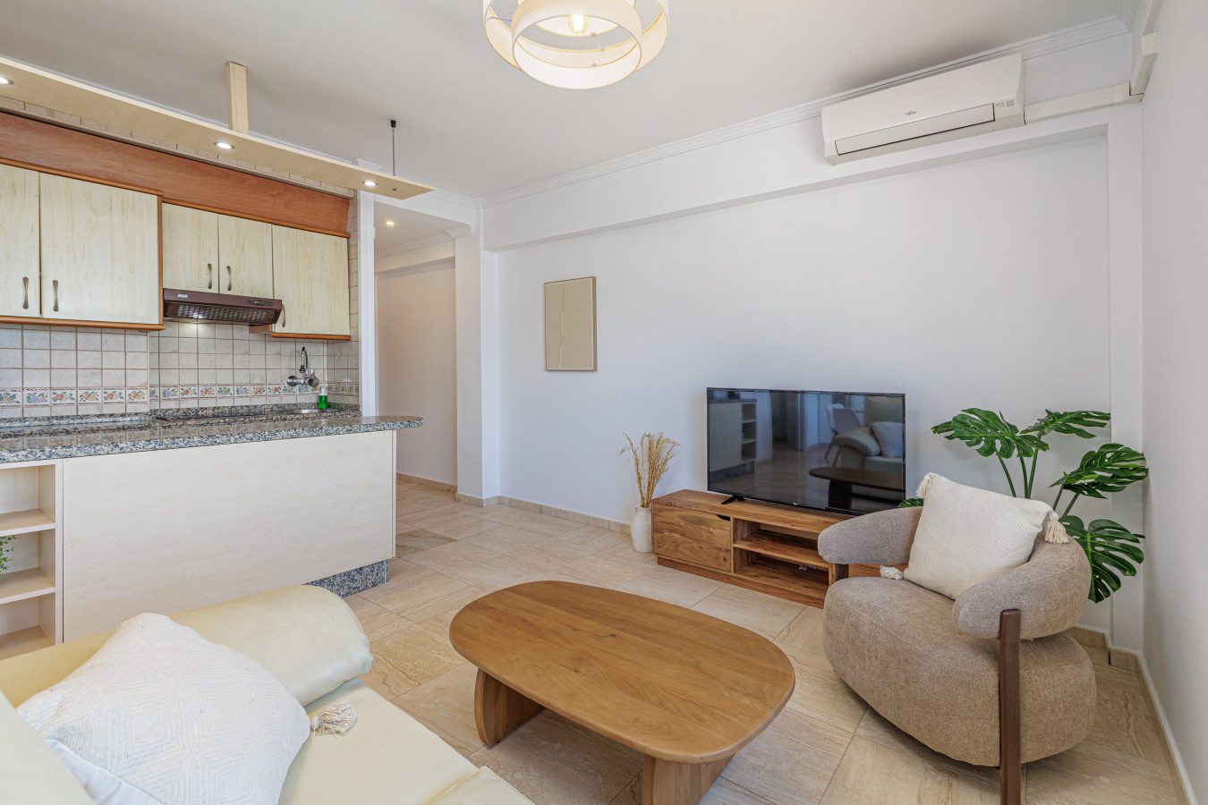 Seamless flow from the cozy living room to the fully equipped kitchen.