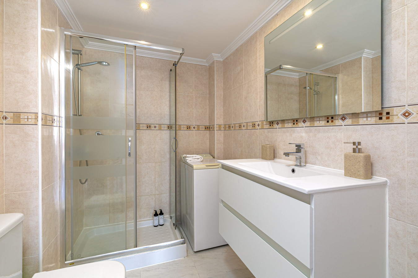 Spotless modern bathroom with a spacious walk-in shower.