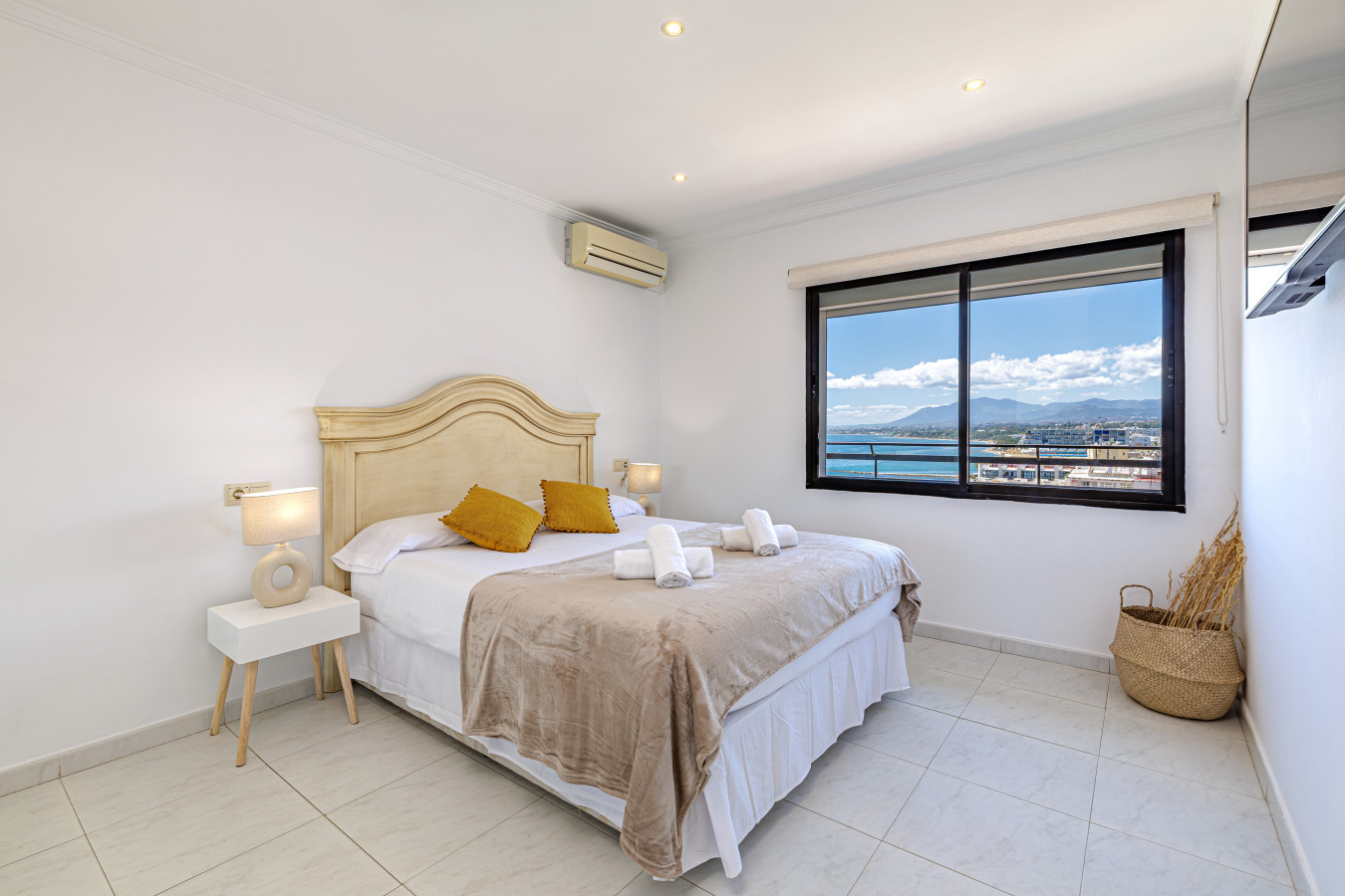 Comfortable bedroom featuring natural light and stunning Marbella city views.