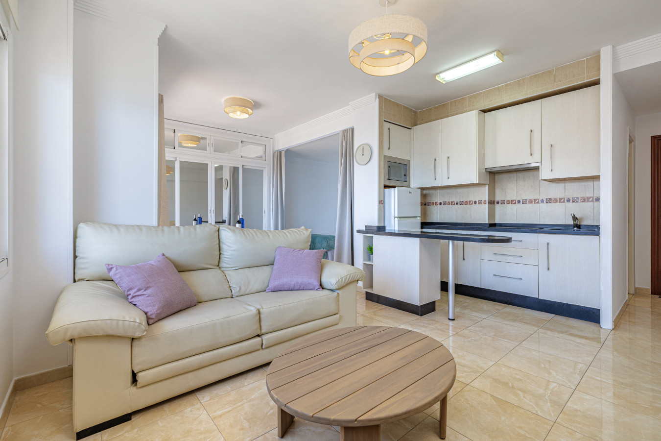 Open concept living area flowing seamlessly into the fully equipped kitchen.
