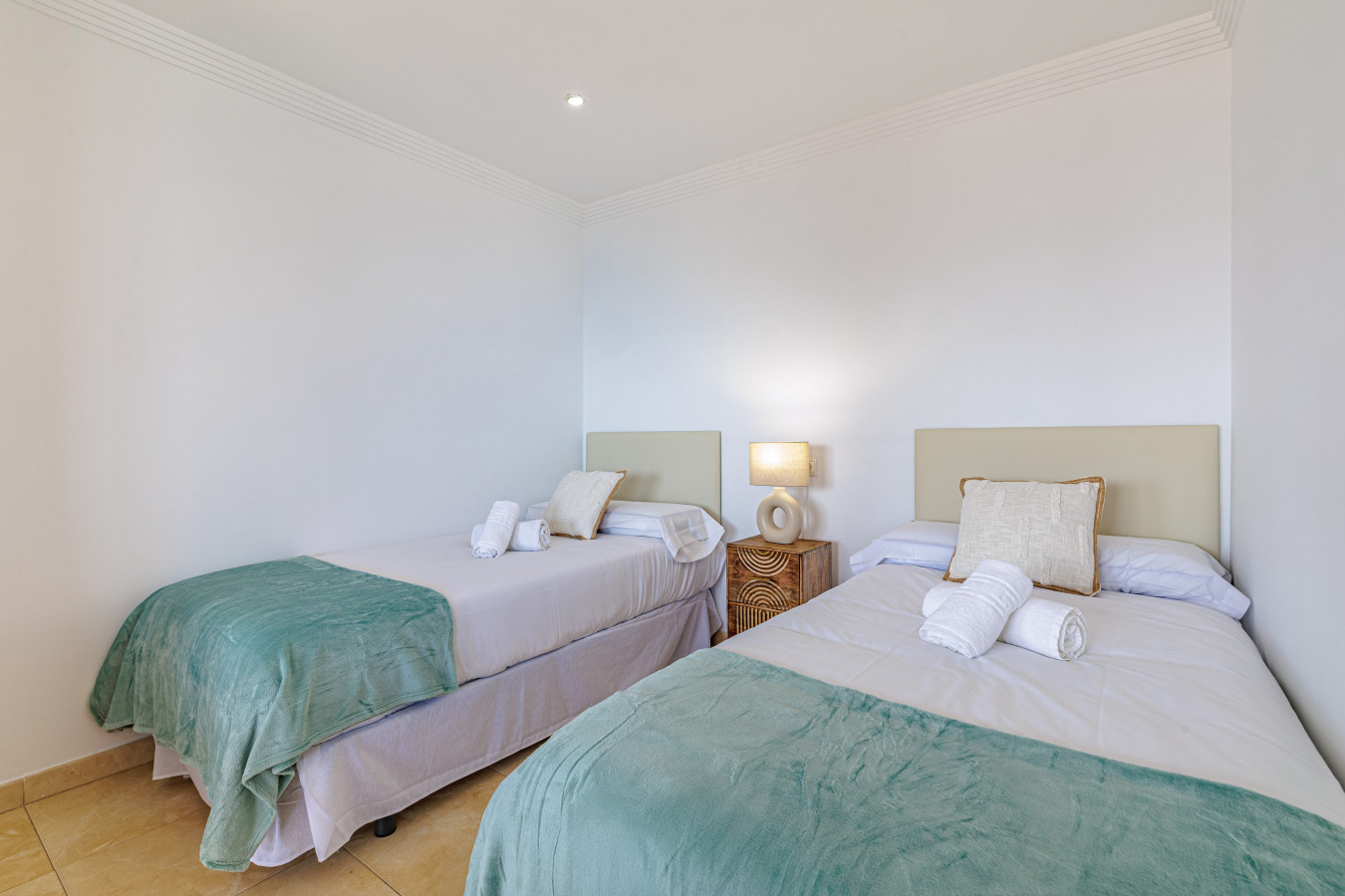 Rest easy in the tranquil bedroom, outfitted with comfortable twin beds, fresh linens, and bright, coastal-inspired decor.
