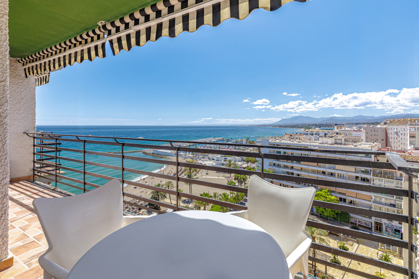 Enjoy your morning coffee on the private balcony with sweeping views of the Mediterranean Sea and Marbella's beachfront.
