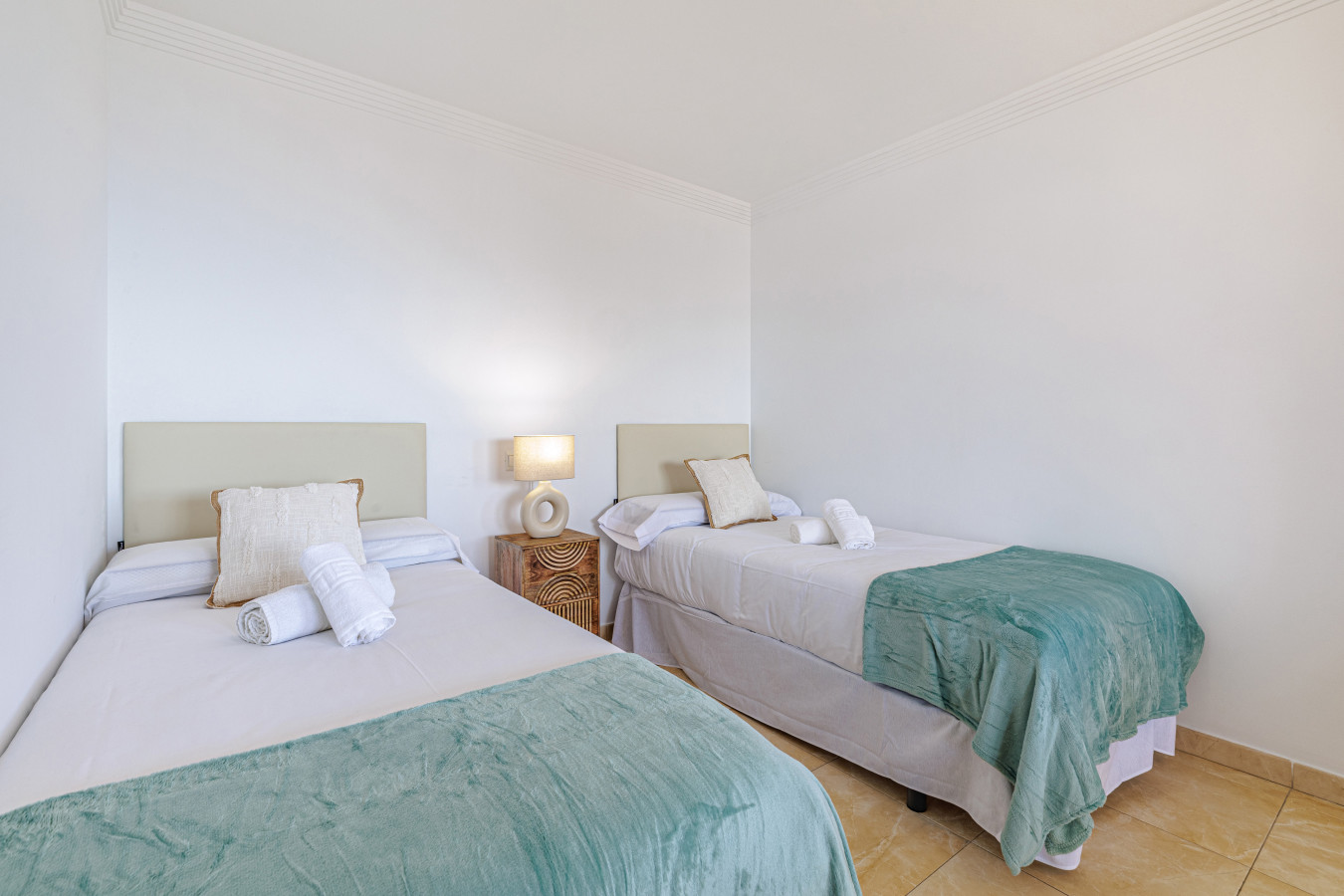 Relaxing and bright bedroom with fresh linens for a perfect night of sleep.