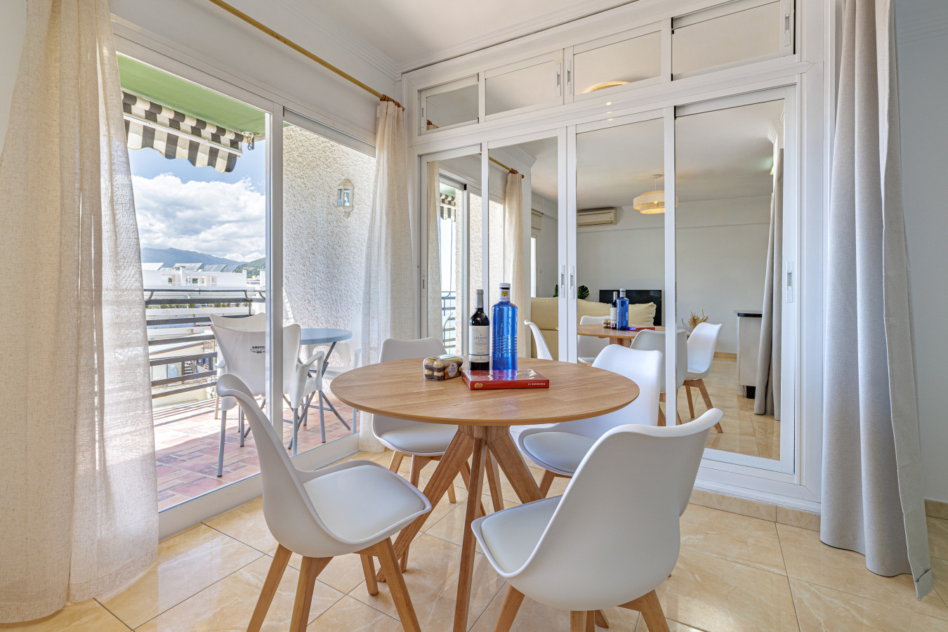Elegant dining space with natural light right next to the balcony access.