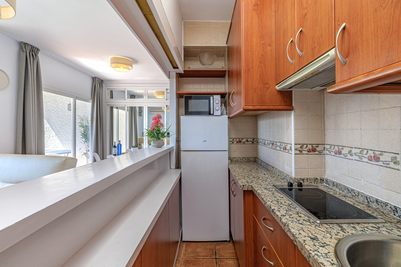Fully equipped kitchen with a stovetop, microwave, and full-size fridge for all your culinary needs.