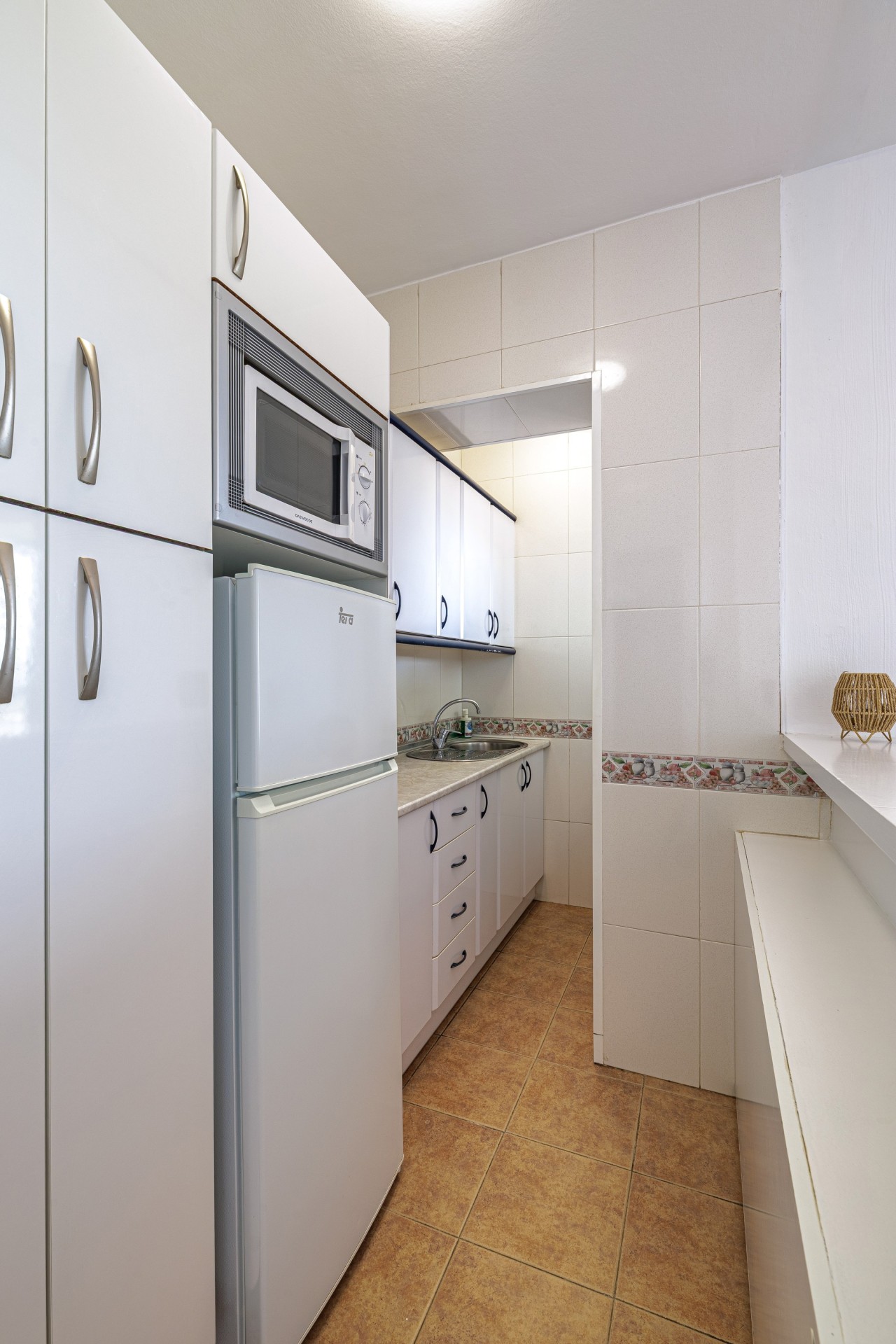 Kitchen with fridge freezer, microwave and ample storage