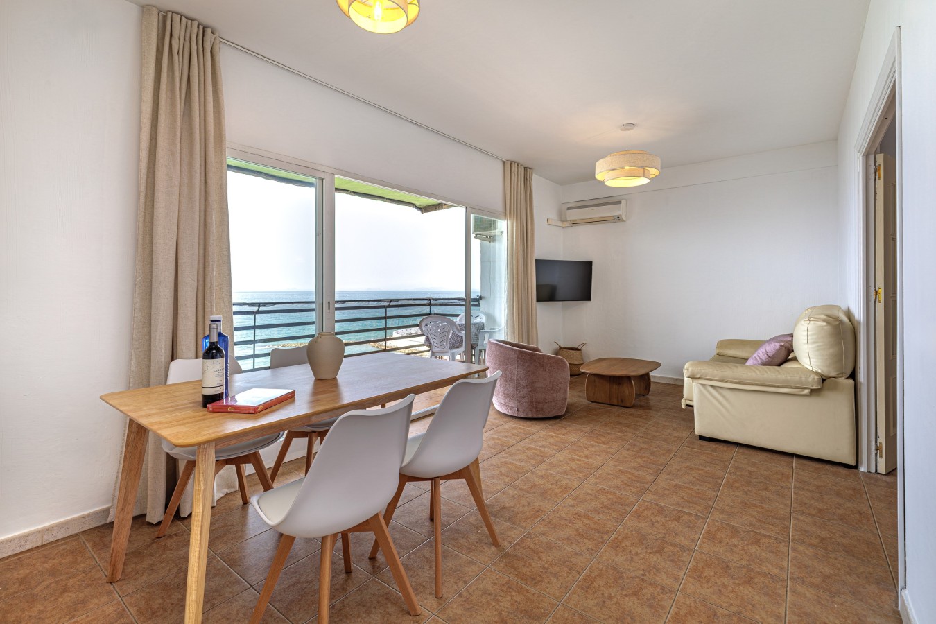Dining table for four with sea views and a smart TV