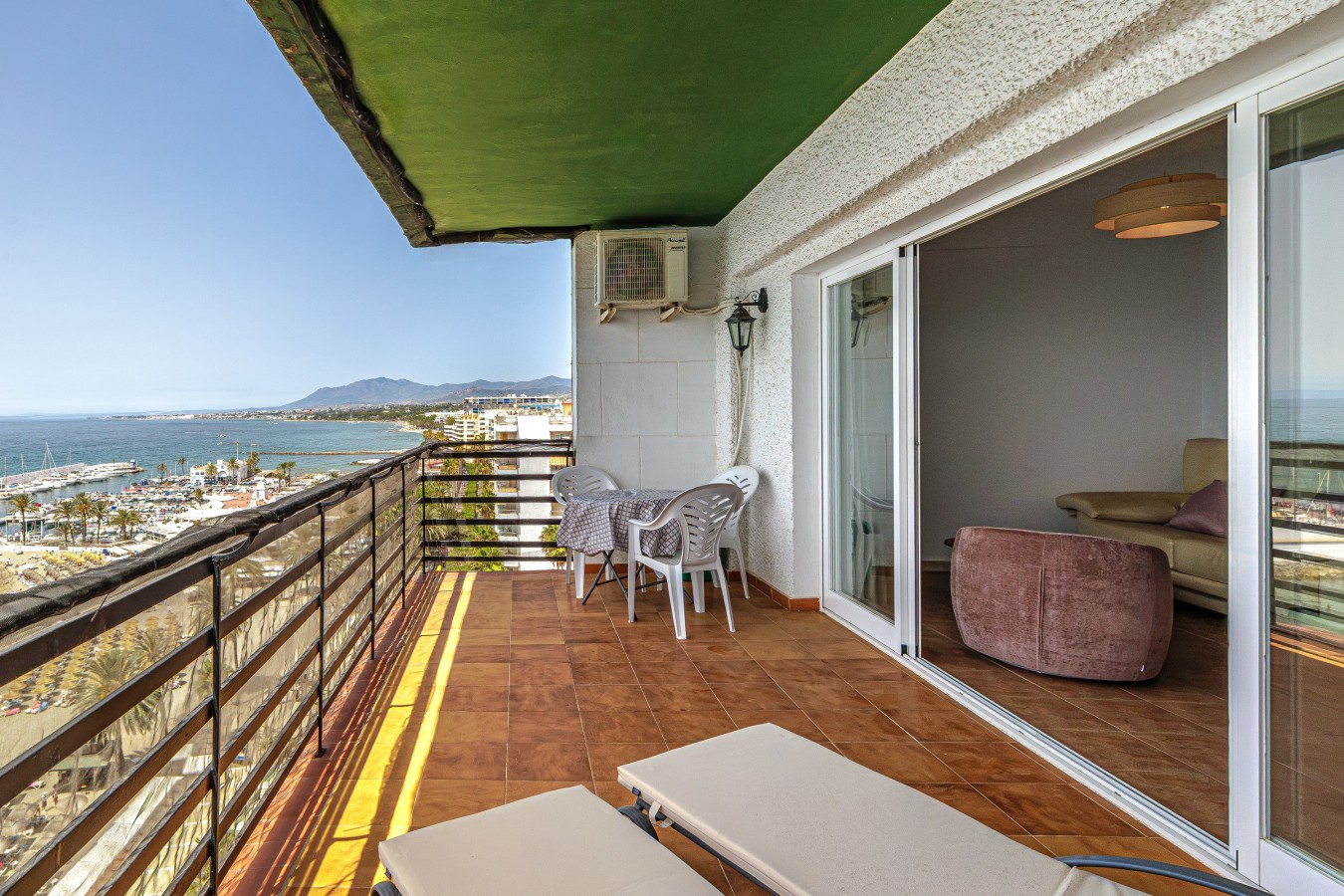 Balcony running the width of the apartment, looking along the coast