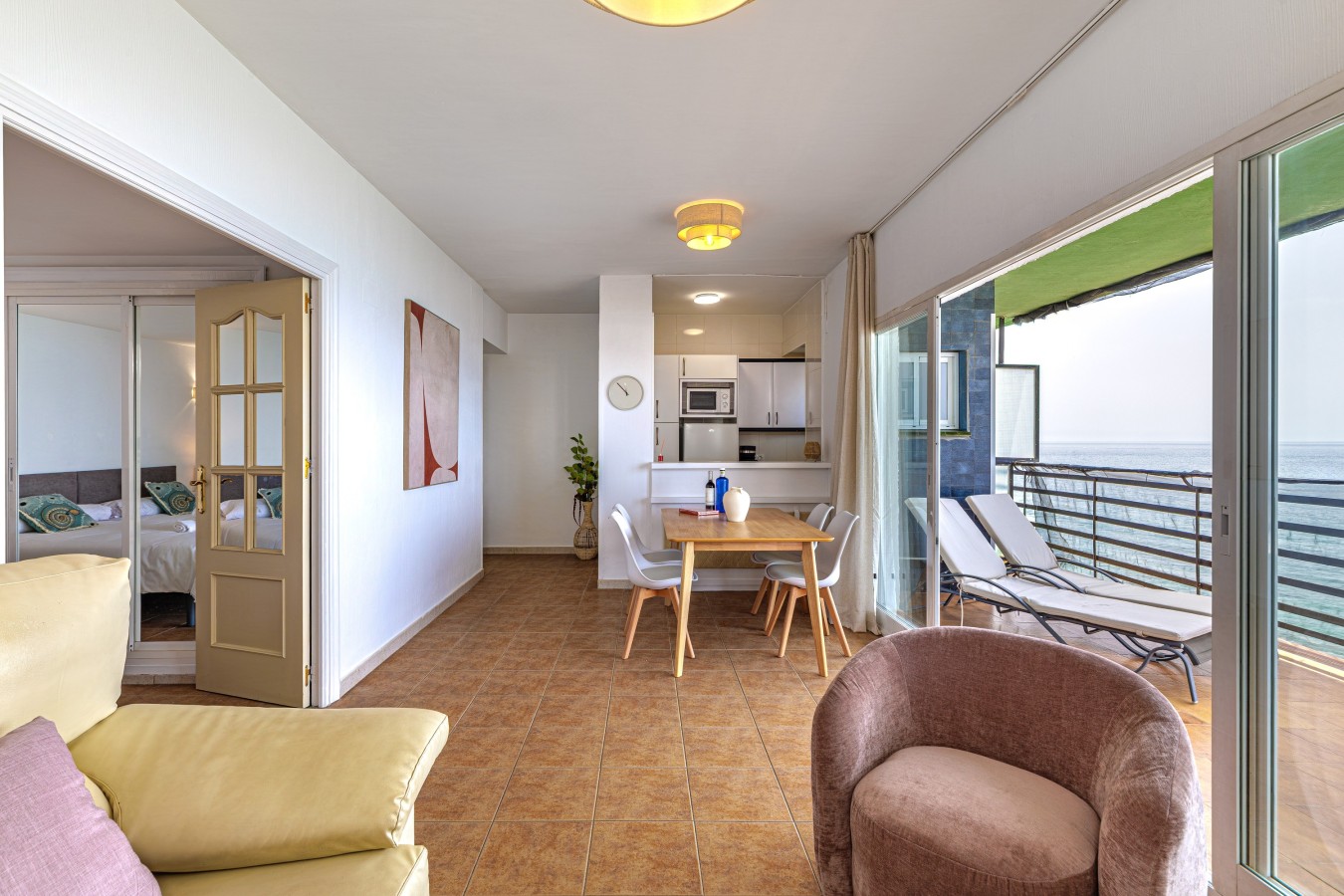 Open living and dining space with the balcony beyond