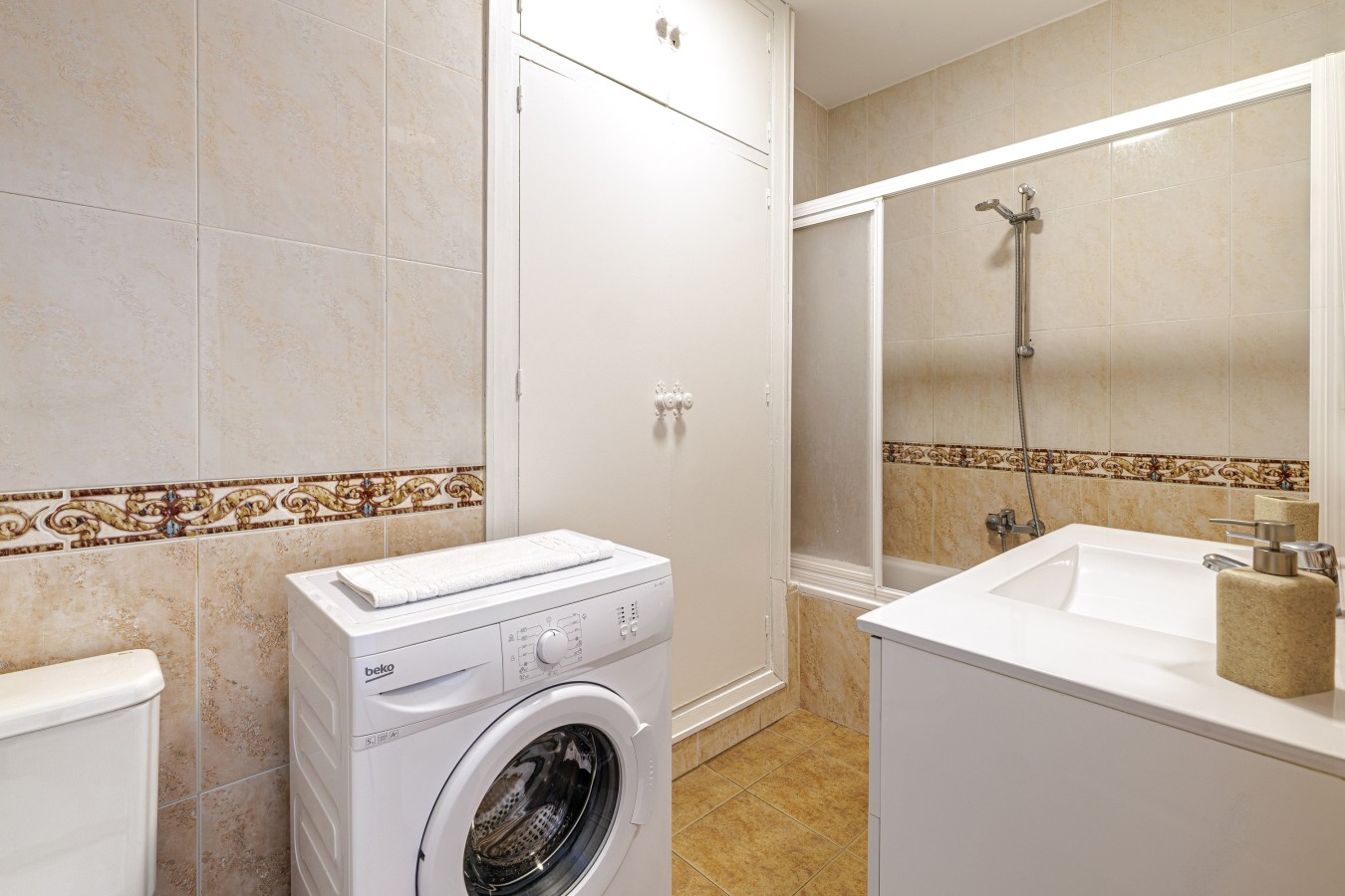 Bathroom with walk-in shower and washing machine