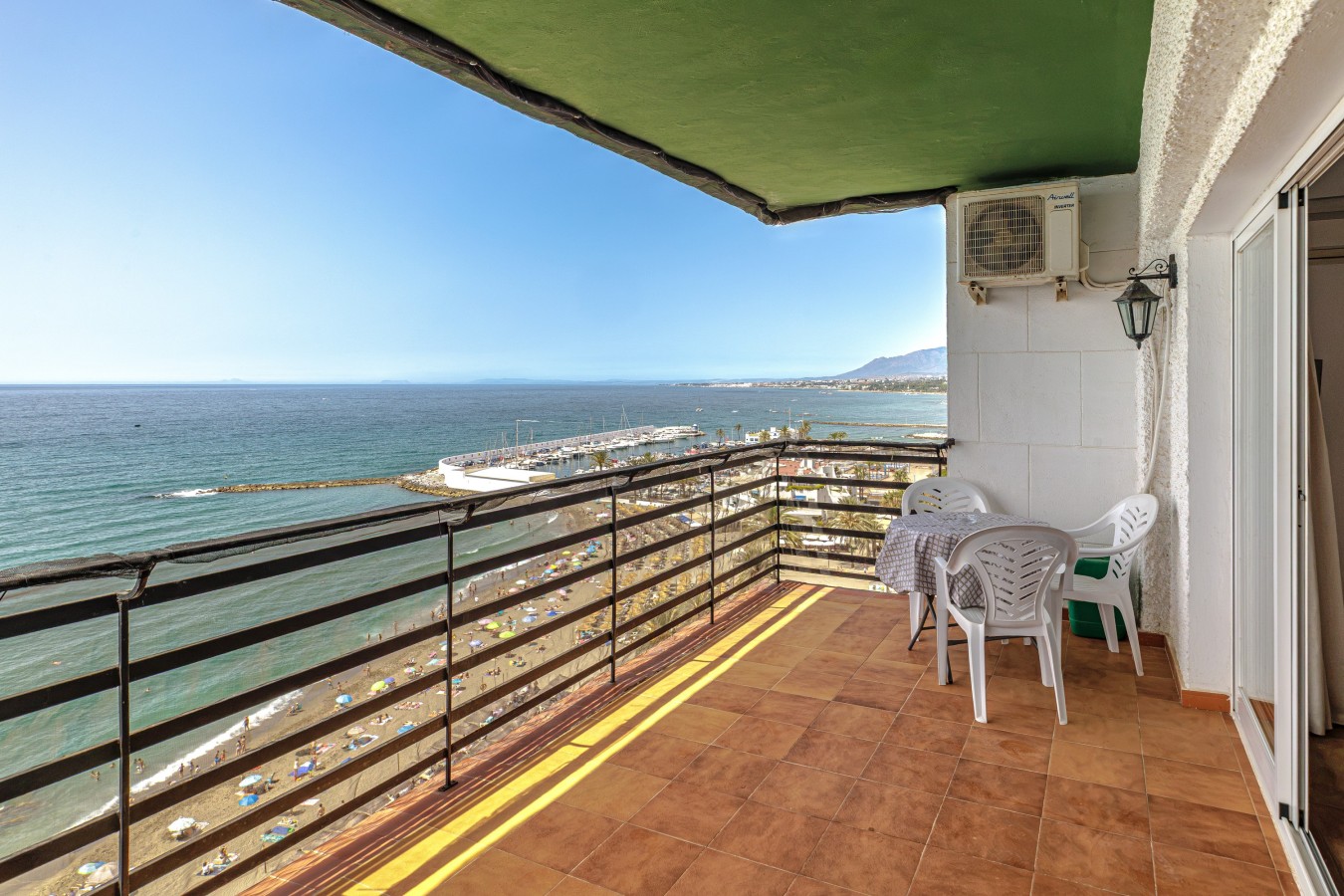Balcony table and chairs facing the sea
