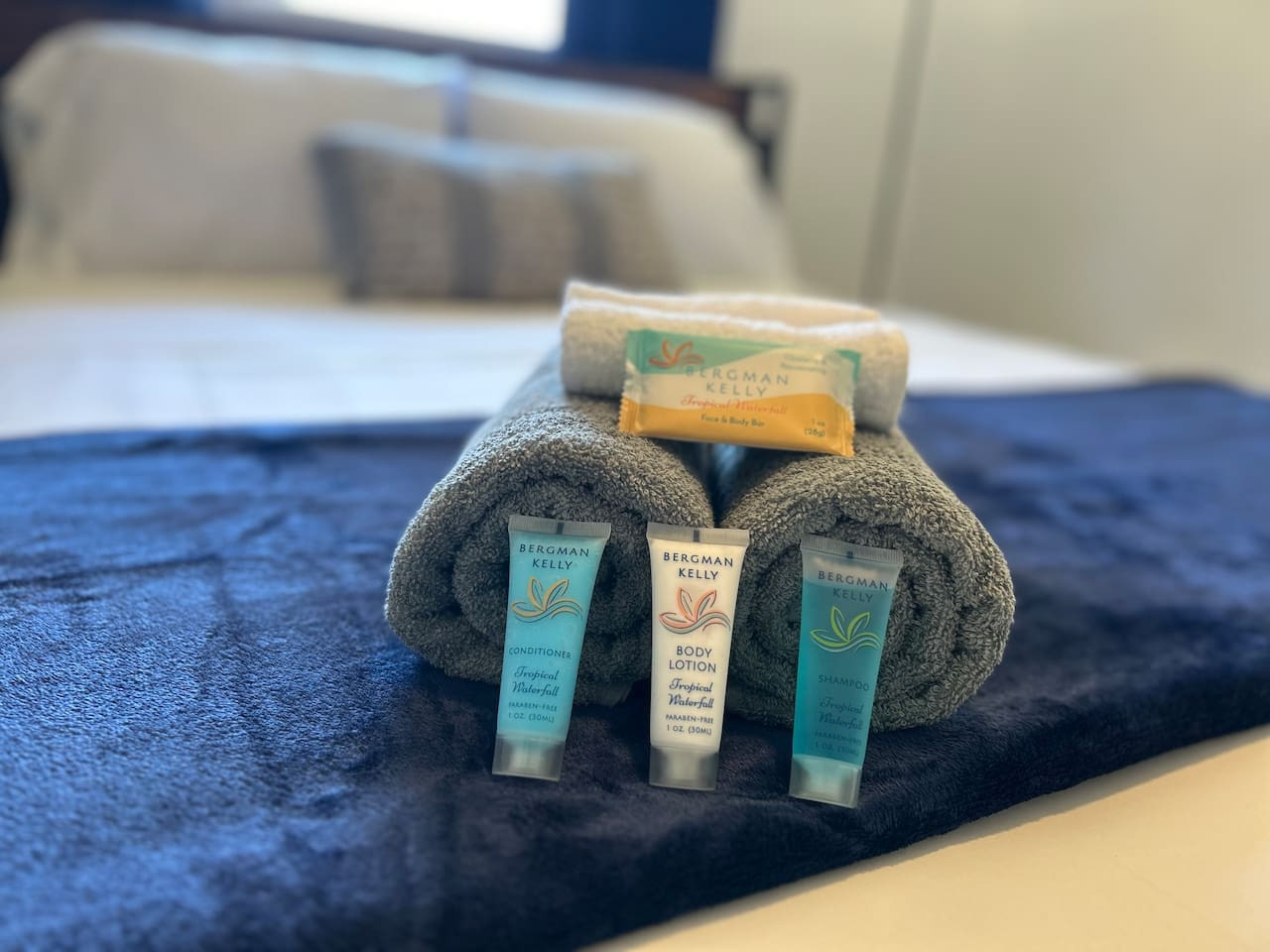 A second stack of towels and toiletries is stocked for the group, so nobody has to pack their own.