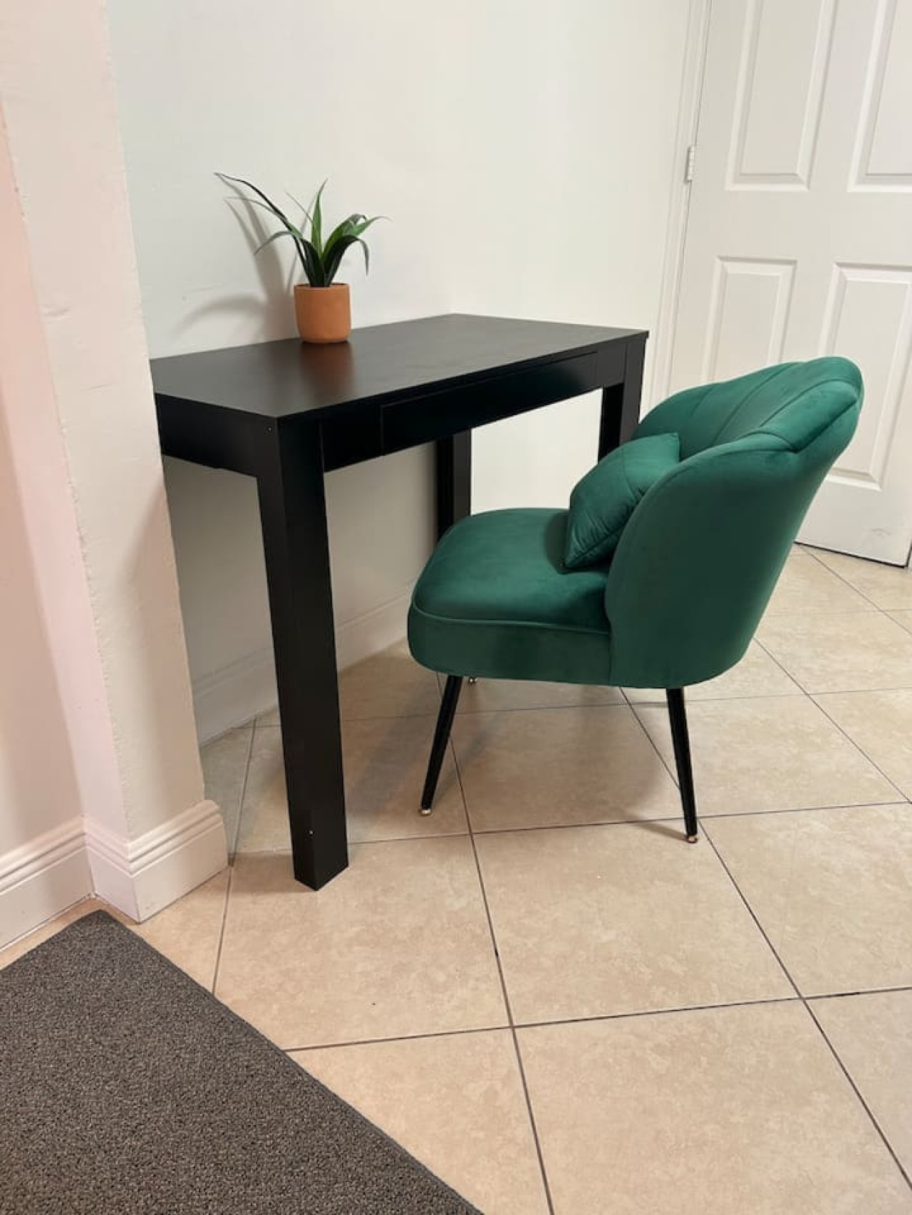 Tucked into a corner, a small desk and green accent chair make room for anyone on the trip who still has work to finish.
