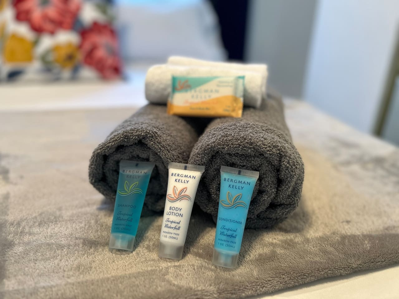 Towels are rolled and travel-size toiletries set out for guests on arrival.