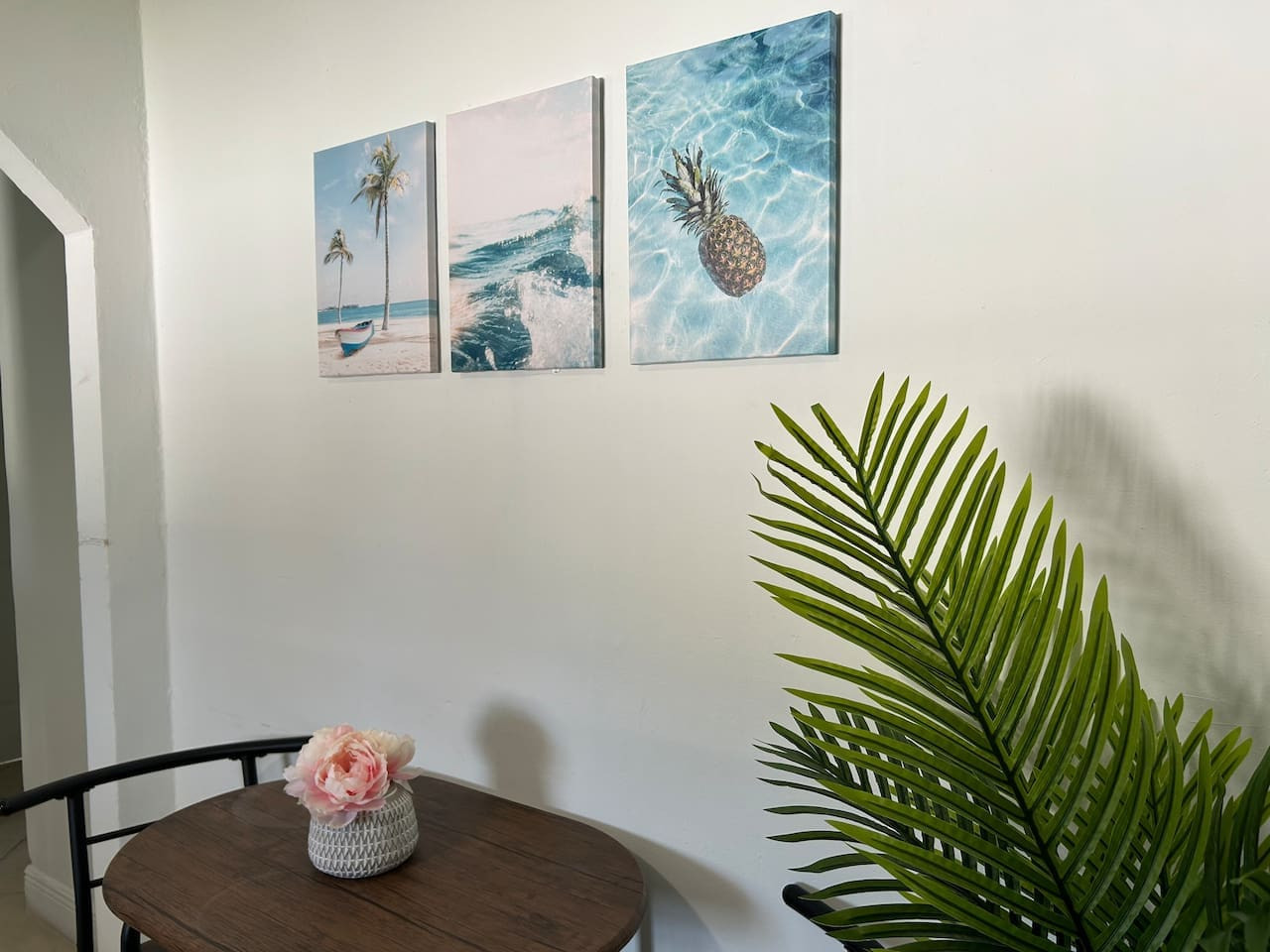 Framed beach-themed art hangs over this dining table, a small nod to the coastline this part of Florida is known for.