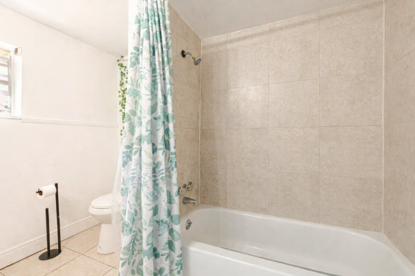 A tub-and-shower combo with a tiled surround gives guests a bath option, not just a shower.