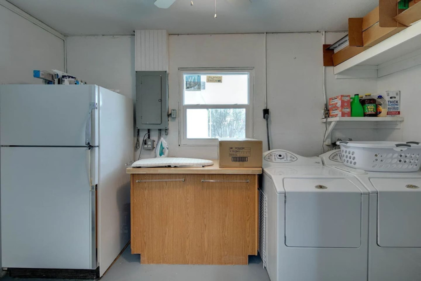 An in-unit washer and dryer sit next to a spare refrigerator, useful for a group staying long enough to need both.