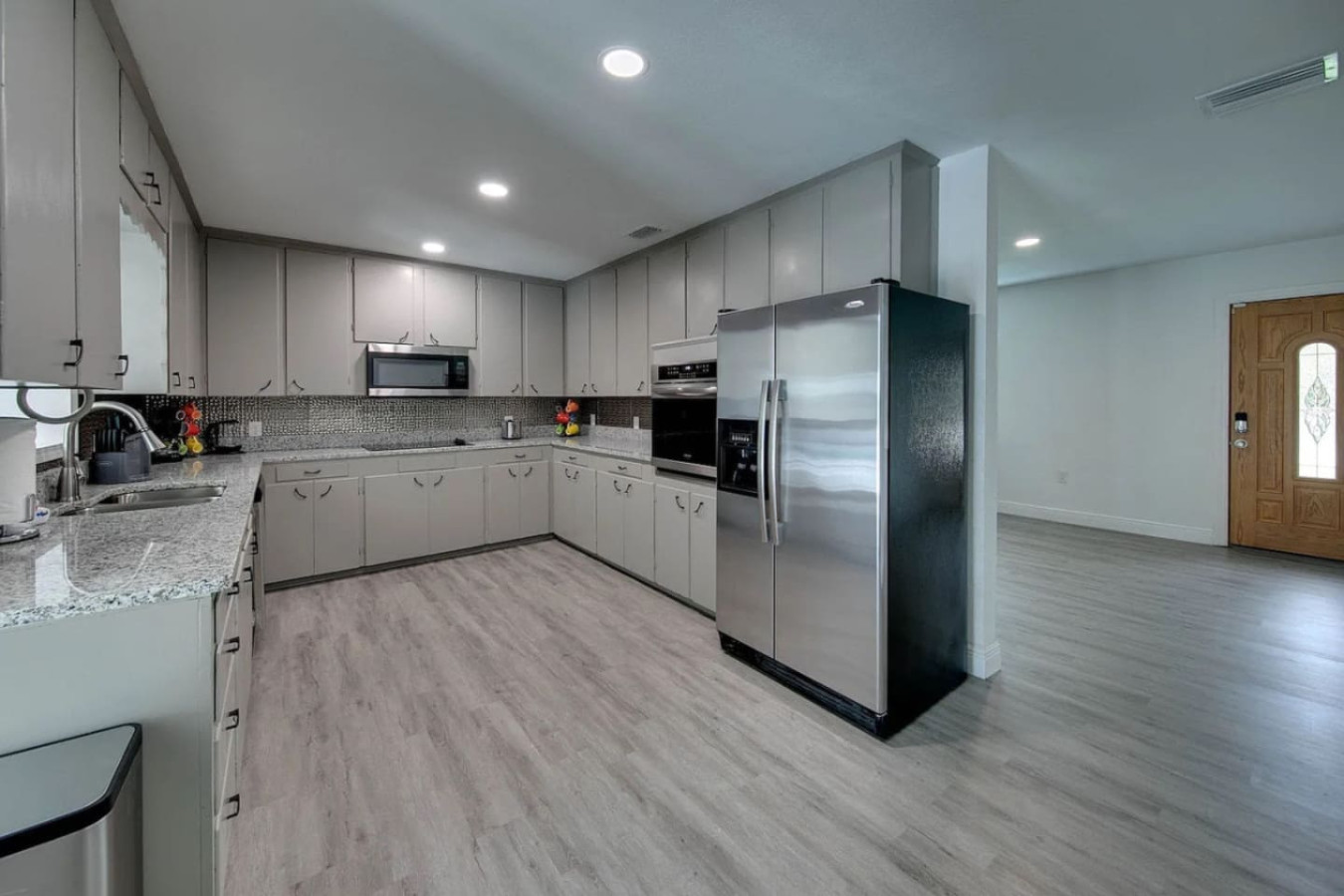 Dark cabinets and a long run of counter space give this kitchen room for two or three people cooking side by side.