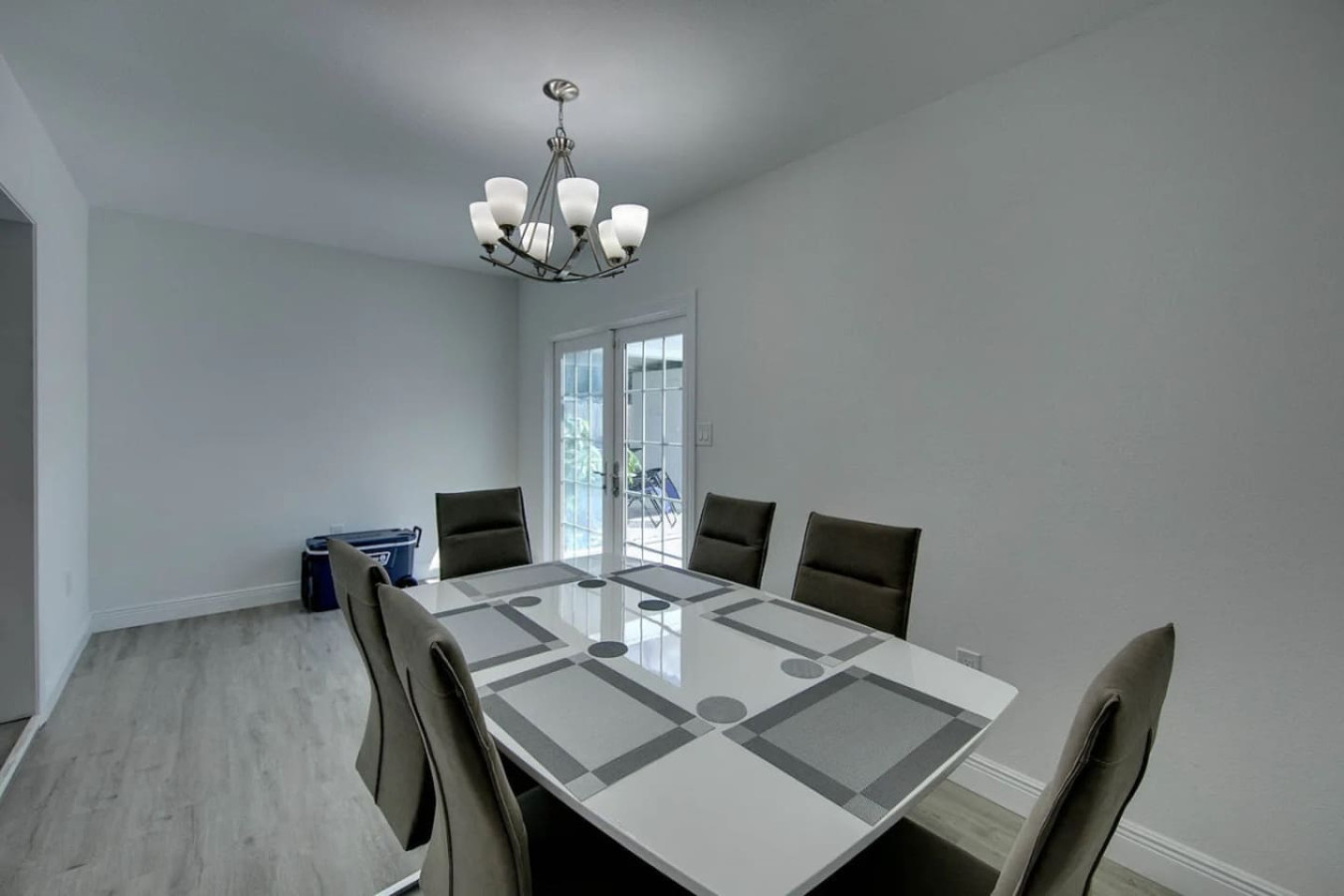 From the dining table, the view runs straight out through the glass doors to the pool and lanai.