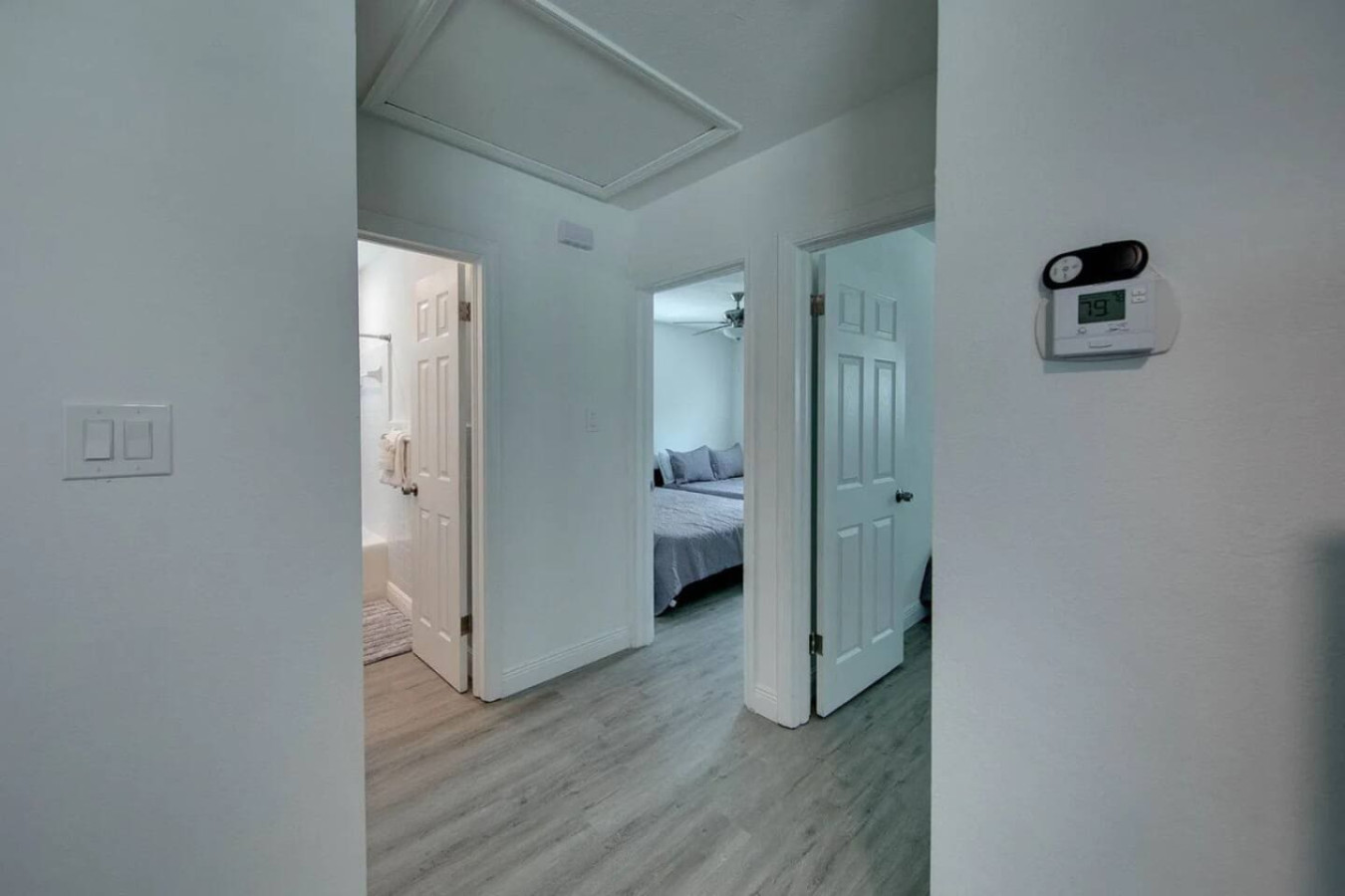 A hallway connects the living space to the bedrooms, keeping all four within easy reach of the common areas.