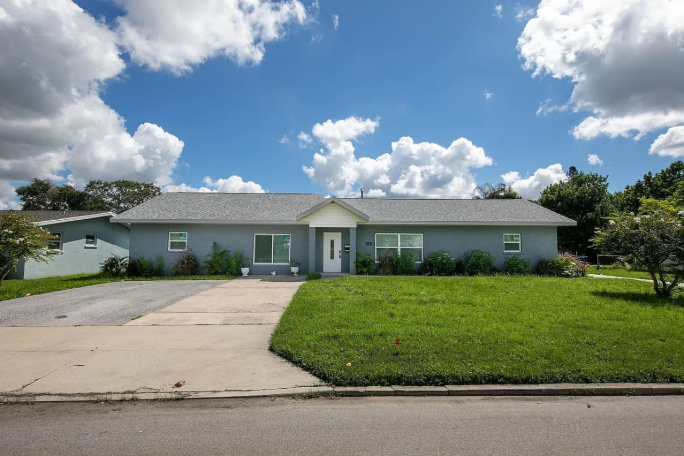 A wider shot of the front exterior and driveway.