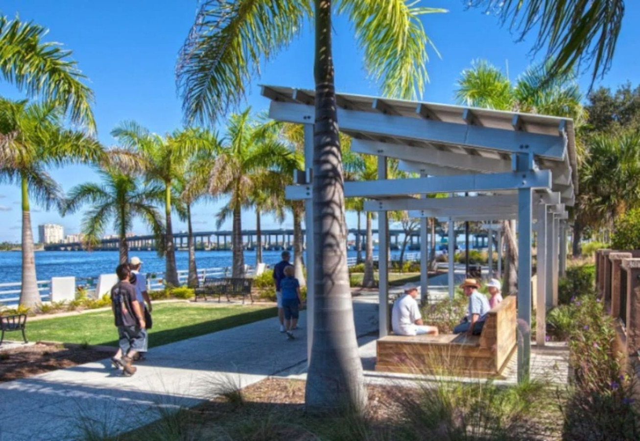 A riverfront park walkway with a covered pergola, part of the public riverside space along the Manatee River near the property.