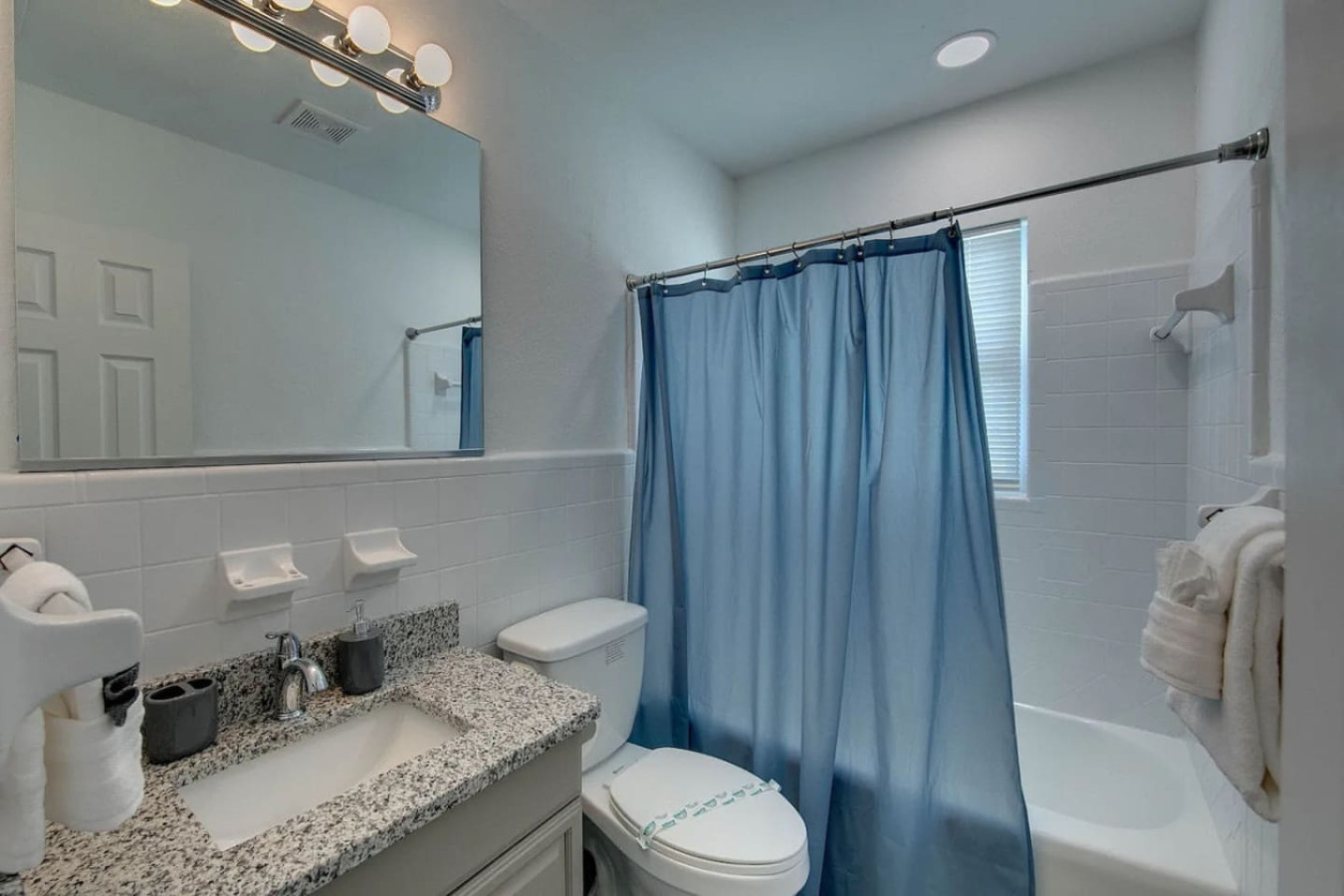New tile and a clean vanity set the tone in this bathroom, one of three the house has to spread 16 guests across.