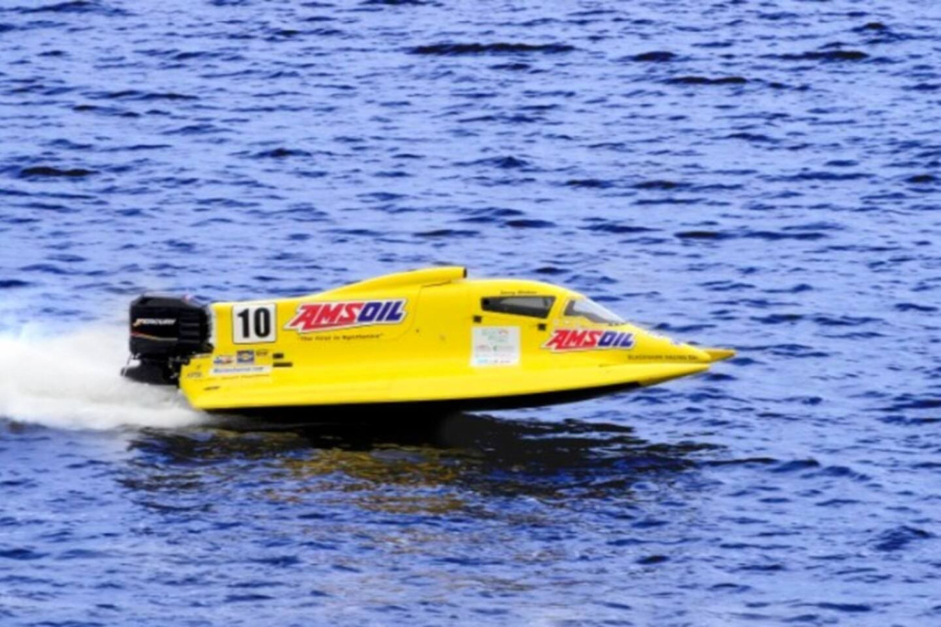 An offshore powerboat races across the water nearby.