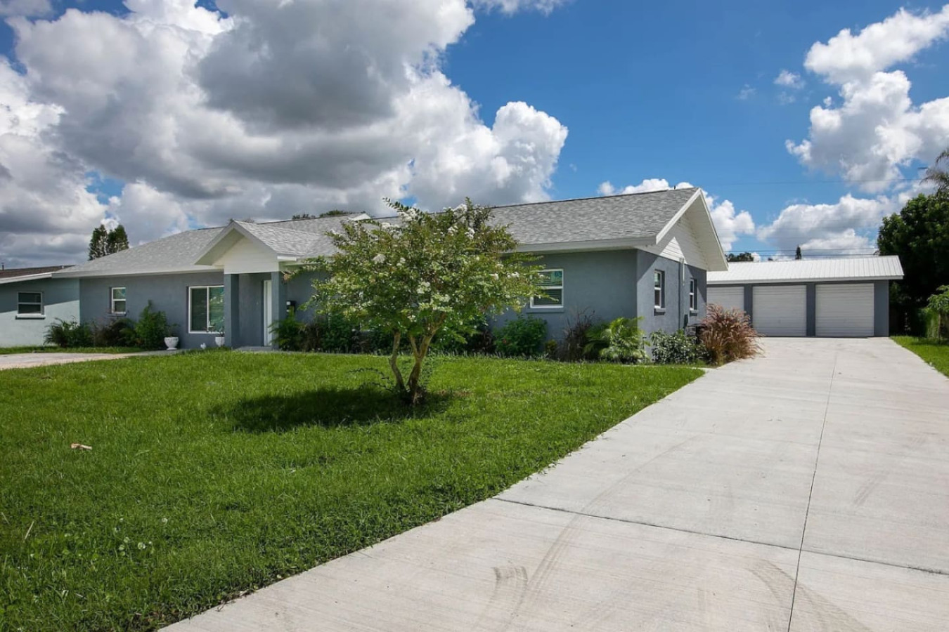 The home's driveway seen from the street. The property has two separate driveways, one that fits six cars and another that fits four.
