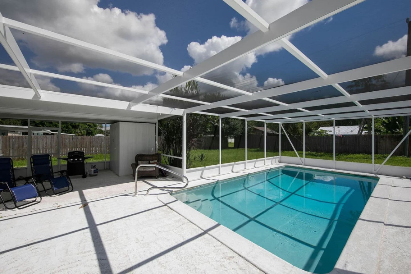 The same lanai and pool from another angle, with deck space wrapping the water on both sides.