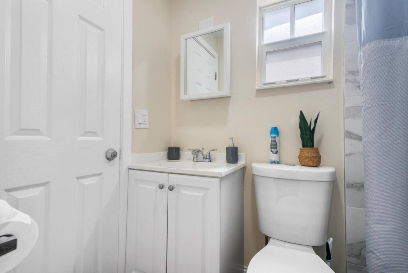 A cozy bathroom attached directly to its own bedroom, with a private stand-up shower.