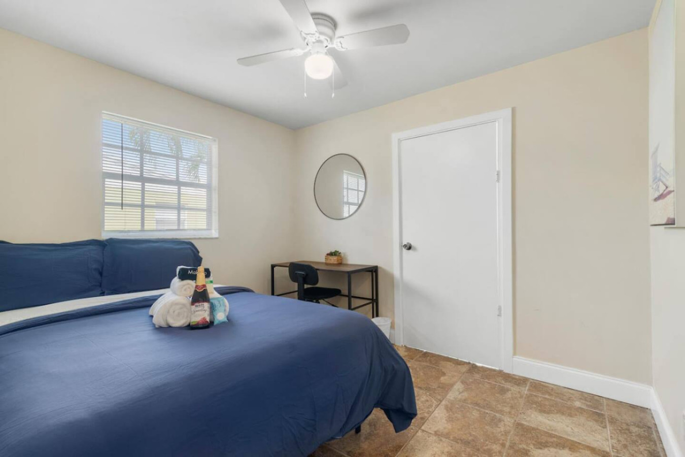 A private bedroom with a full-size bed and open closet storage.