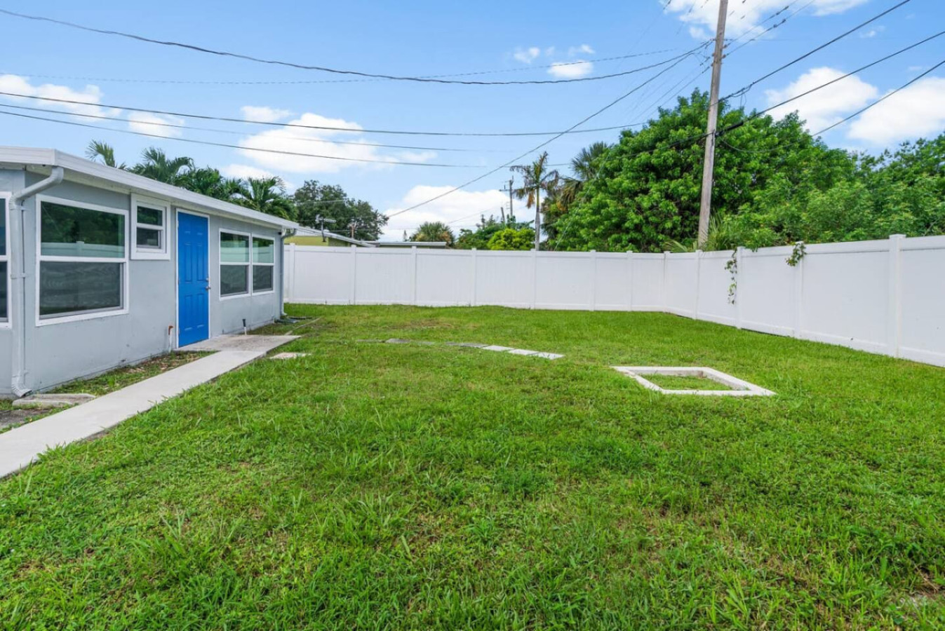 The fully fenced backyard, the property's real gathering space: room for a circle of chairs, a yoga mat layout, or a quiet walk between sessions, with the privacy a retreat group needs.