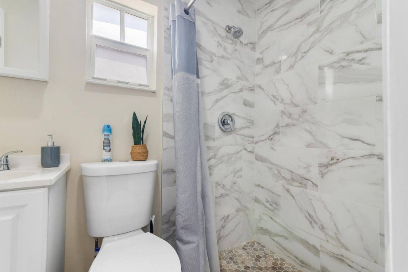 A second angle on one of the remodeled bathrooms and its stand-up shower.