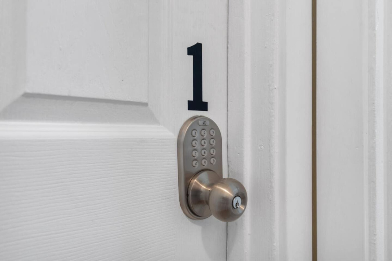An electronic keypad lock on one of the private bedroom doors.