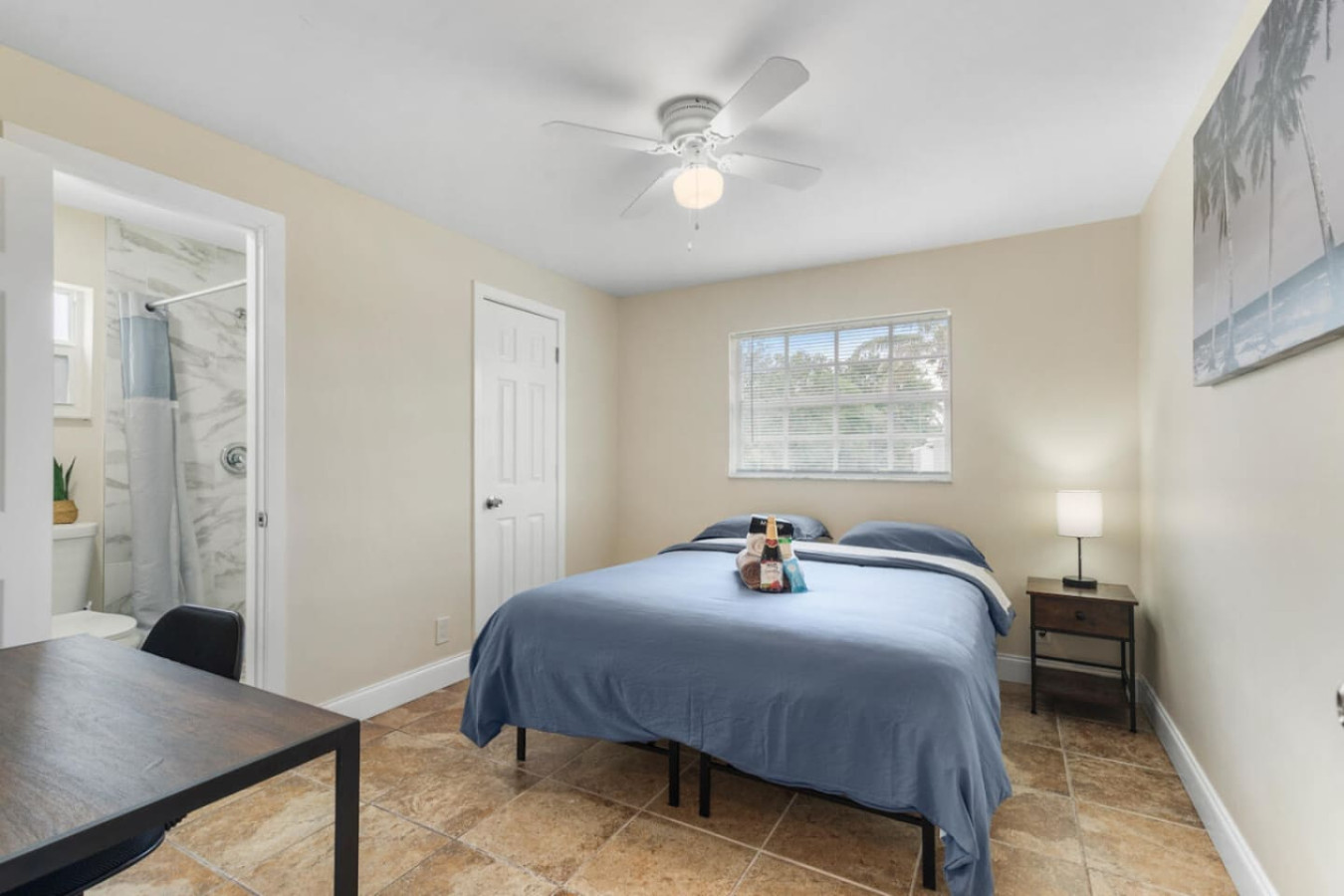 One of the larger private bedrooms, with wall art, a full-size bed, and a walk-in closet.