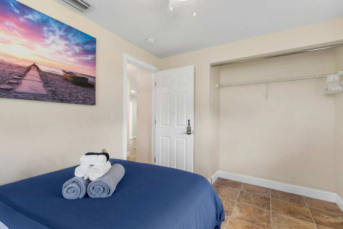 A bedroom entrance with closet space and hangers already in place.