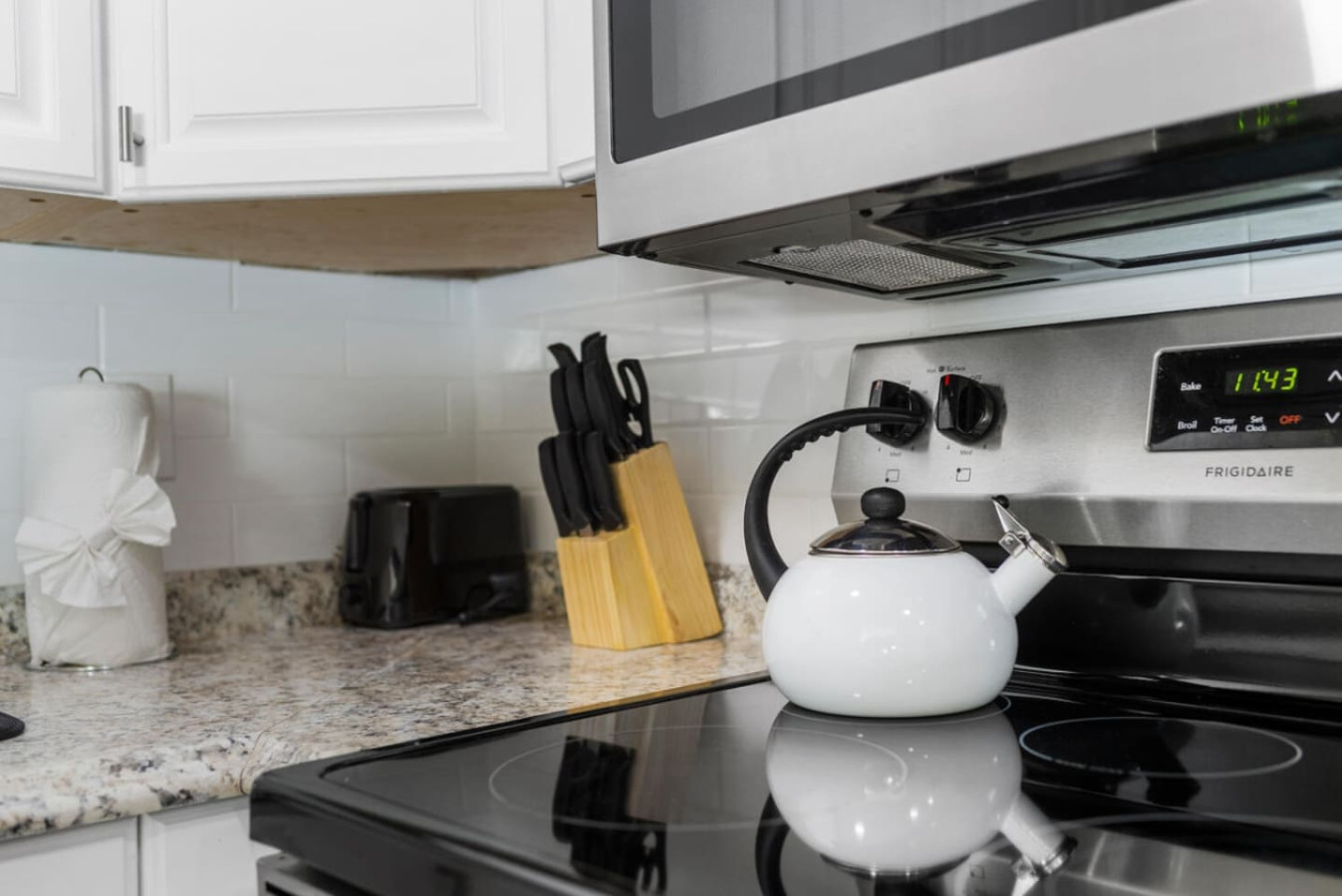 A hot water kettle, kitchen knife set, and toaster, ready for a group cooking real meals rather than ordering out.