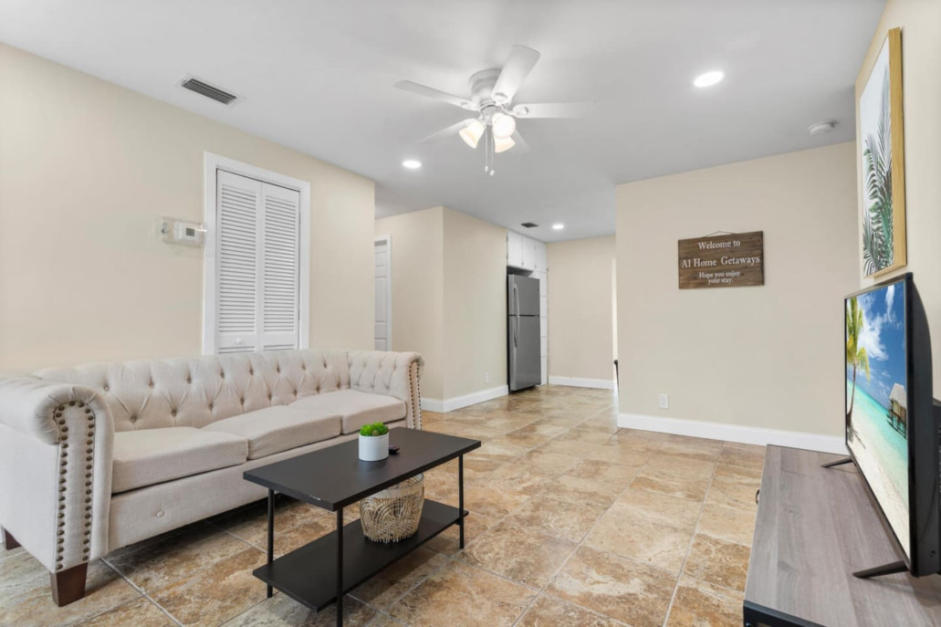 Just inside the front door, this living area opens straight through to the kitchen and sunroom, so a group can move easily between gathering spaces.